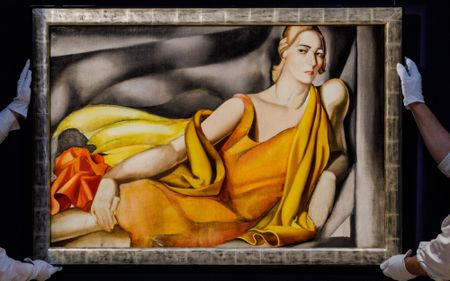 Sotheby's workers carry the Tamara de Lempicka 1929 painting "Femme a la robe jaune"