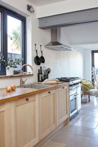 Kitchen with wood units and a copper kitchen tap