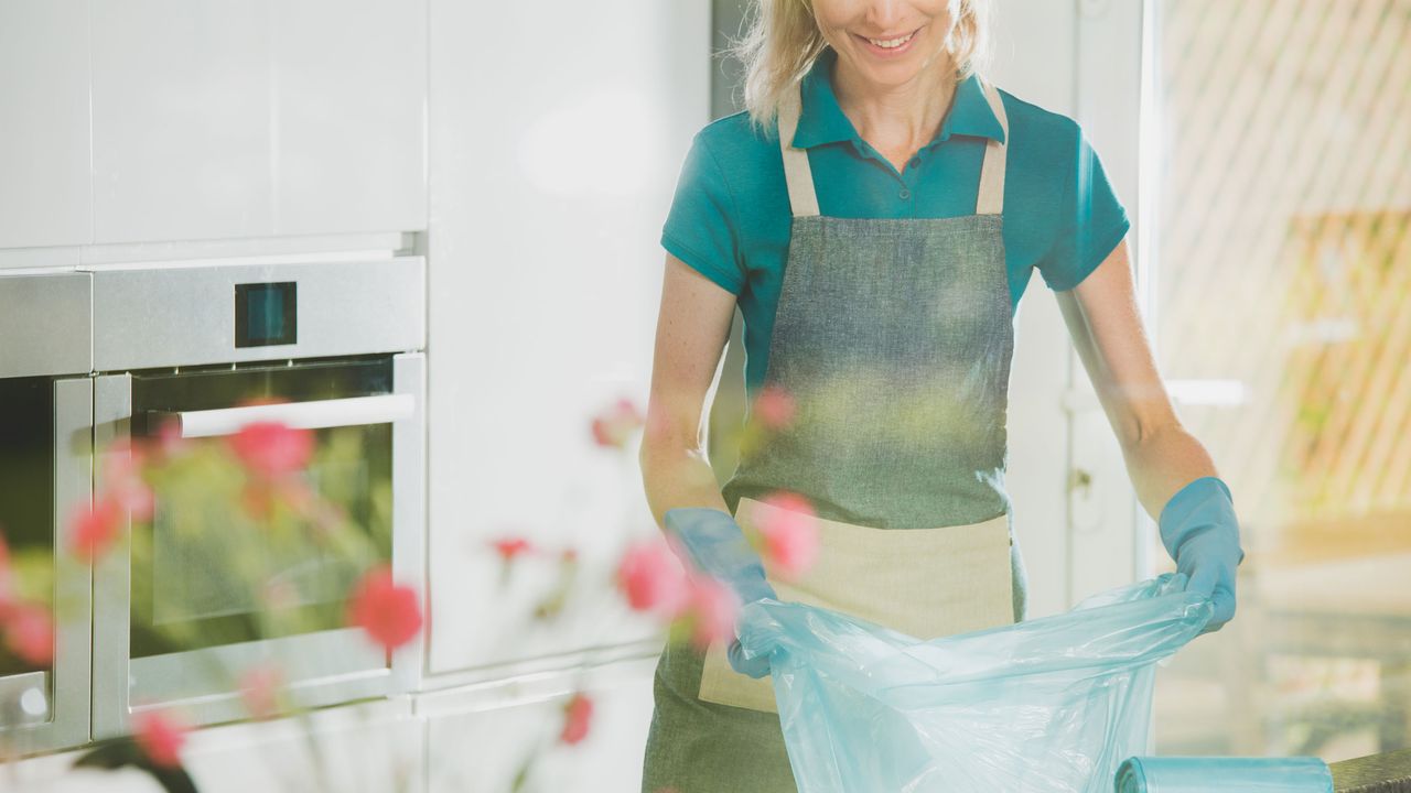 woman changing the bag in the bin