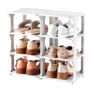 White stackable shoe rack with shoes on white background