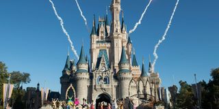 Fireworks go off behind Cinderella's castle at Disney World.