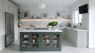 grey and white kitchen with large kitchen island with glass doors and marble splashback