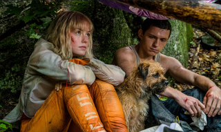 Still shot from Chaos Walking with Tom Holland and Daisy Ridley sitting together.