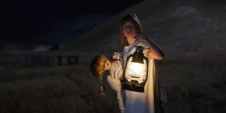 Lulu Wilson carrying the possessed doll in Annabelle: Creation