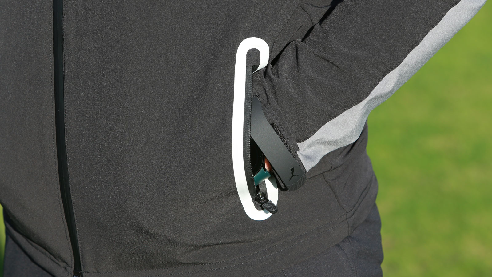 A golfer puts his hand in a pocket