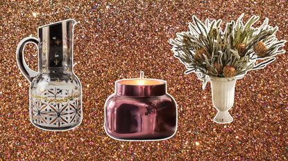 Three holiday hosting essentials from Anthropologie including a pitcher, candle, and batch of dried flowers on a glittery brown/gold background