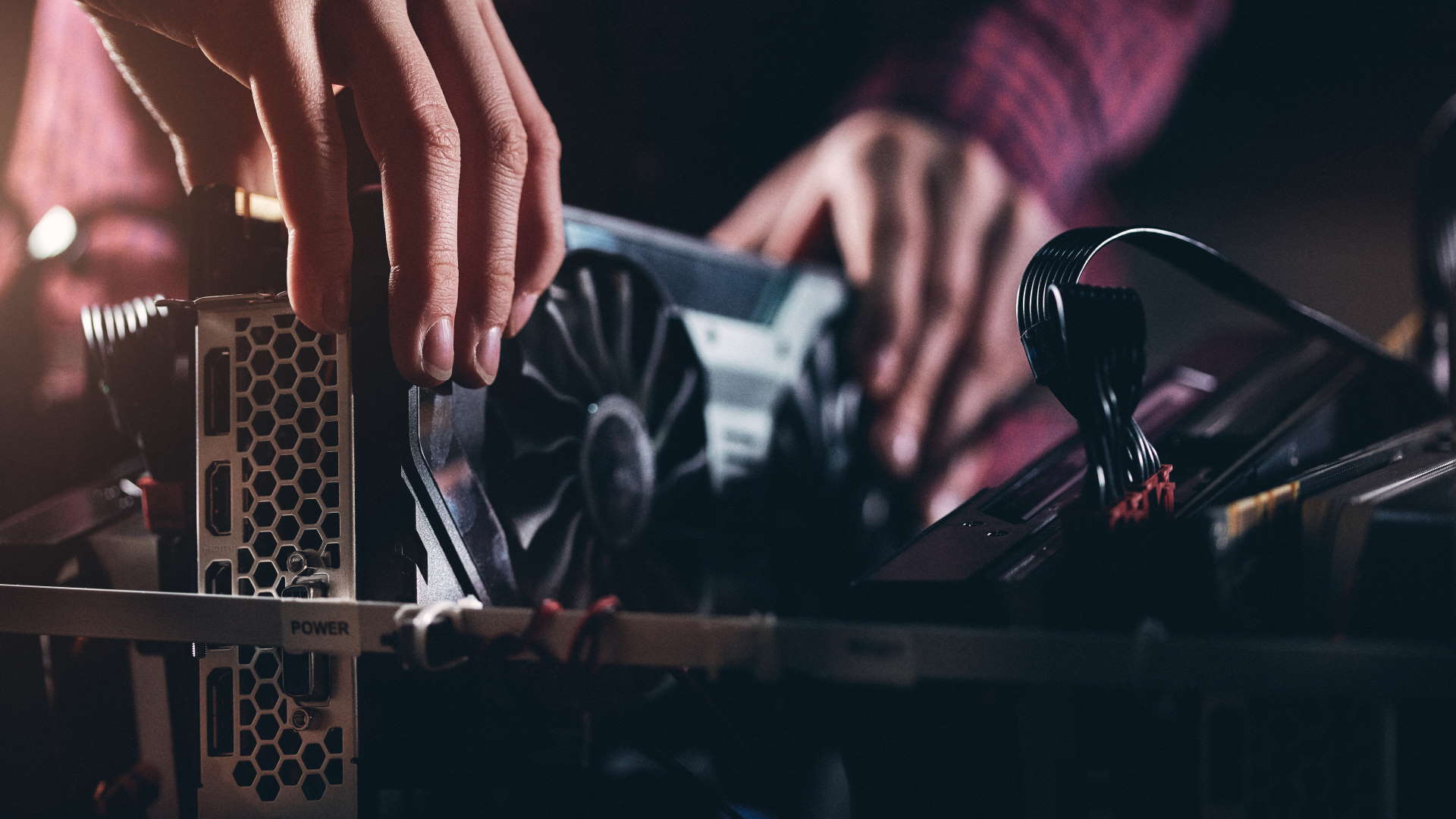 Graphics card being inserted or removed from a cryptocurrency mining setup