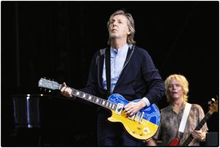 Paul McCartney plays a custom Ukrainian flag Gibson Les Paul onstage