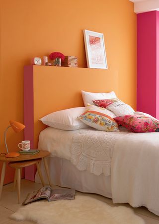 Orange and pink make for a contrasting bedroom scheme