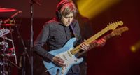 Eric Johnson wears headpnones as he takes a solo on his Strat during the 2023 G3 Tour.