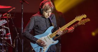 Eric Johnson wears headpnones as he takes a solo on his Strat during the 2023 G3 Tour.