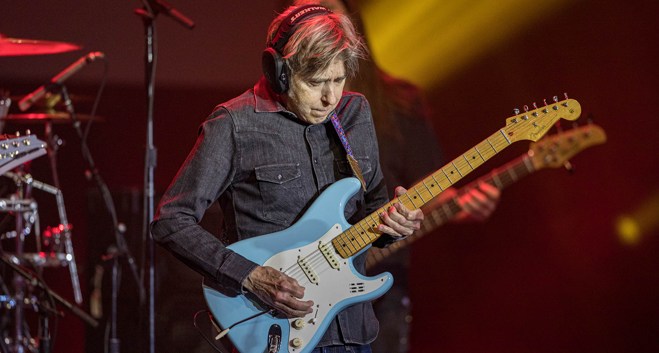 Eric Johnson wears headpnones as he takes a solo on his Strat during the 2023 G3 Tour.