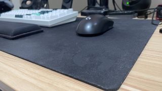 Logitech G840 desk mat XL mouse pad with Logitech mouse and a keyboard and wrist rest on top