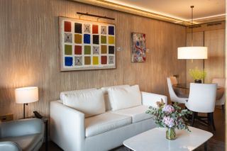 The inside of a room at Almanac Barcelona with a colorful painting by Catherine Parra