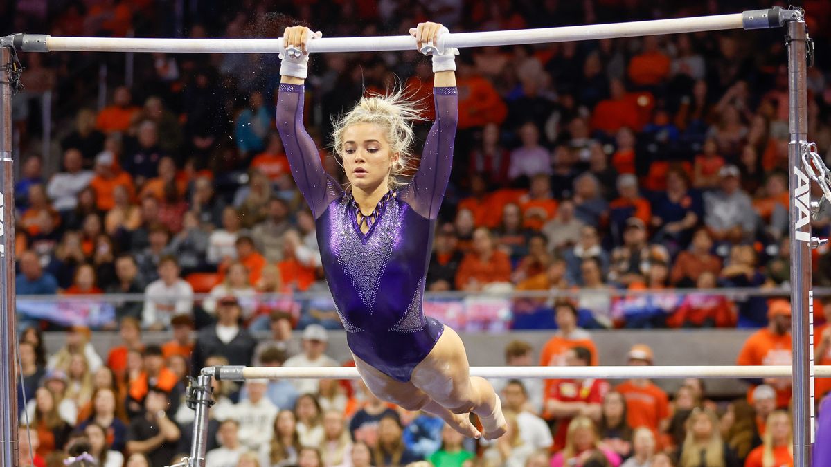 Olivia Dunne, wearing sparkly purple leotard, of LSU warms up on the uneven bars in the NCAA Gymnastics 2024