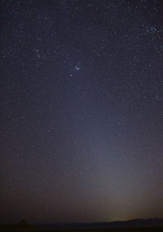 A night sky photo of zodiacal light — a faint column of light extending up from the horizon — on March 1, 2021, in Skull Valley, Utah.