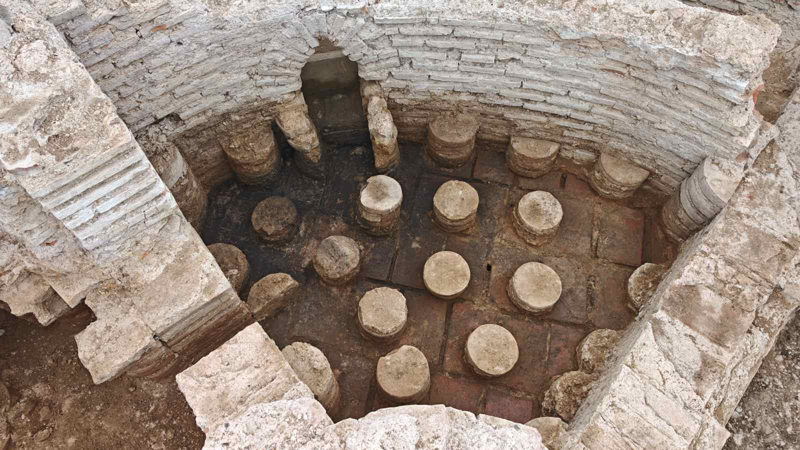 aerial image of an excavated ancient roman bath showing low pillars that supported the floor