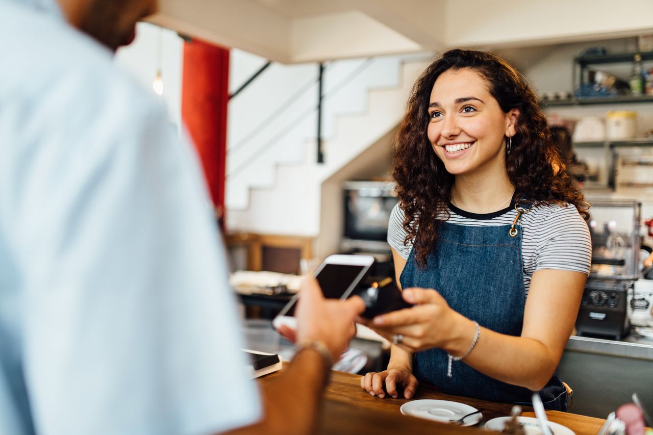 Customer paying in coffee shop