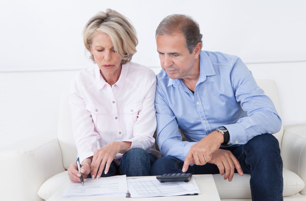 Mature couple doing family finances at home