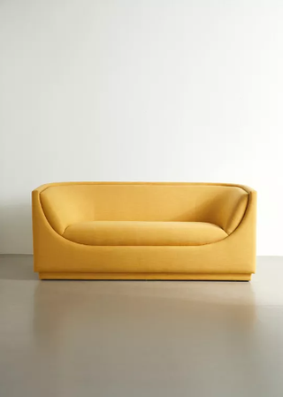 Yellow curved sofa.