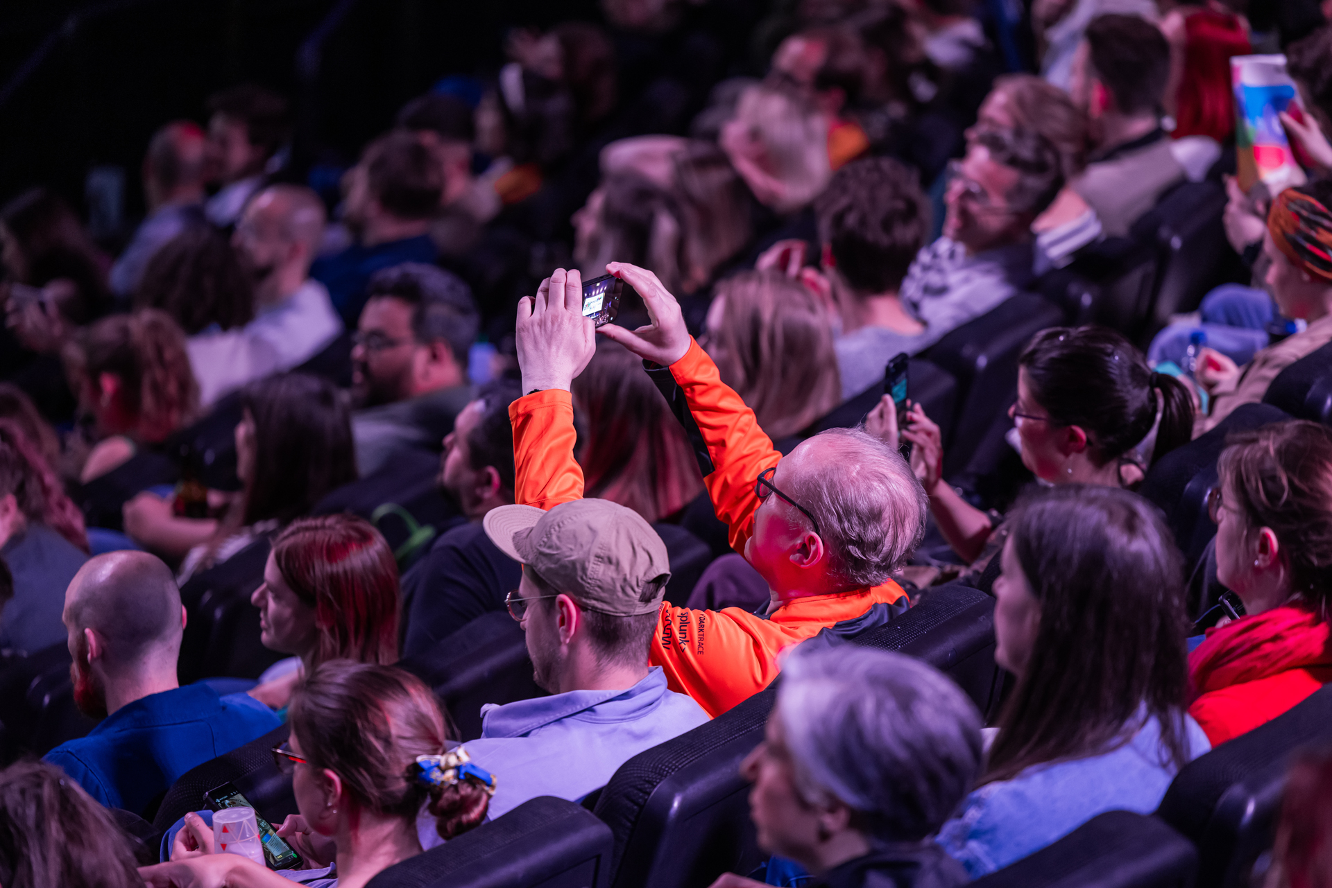 people at a conference with one guy taking a photo