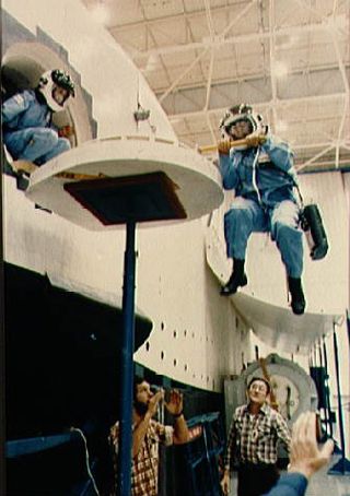 STS-51L crew members practice emergency egress from the Space Shuttle in JSC's mockup and integration laboratory.