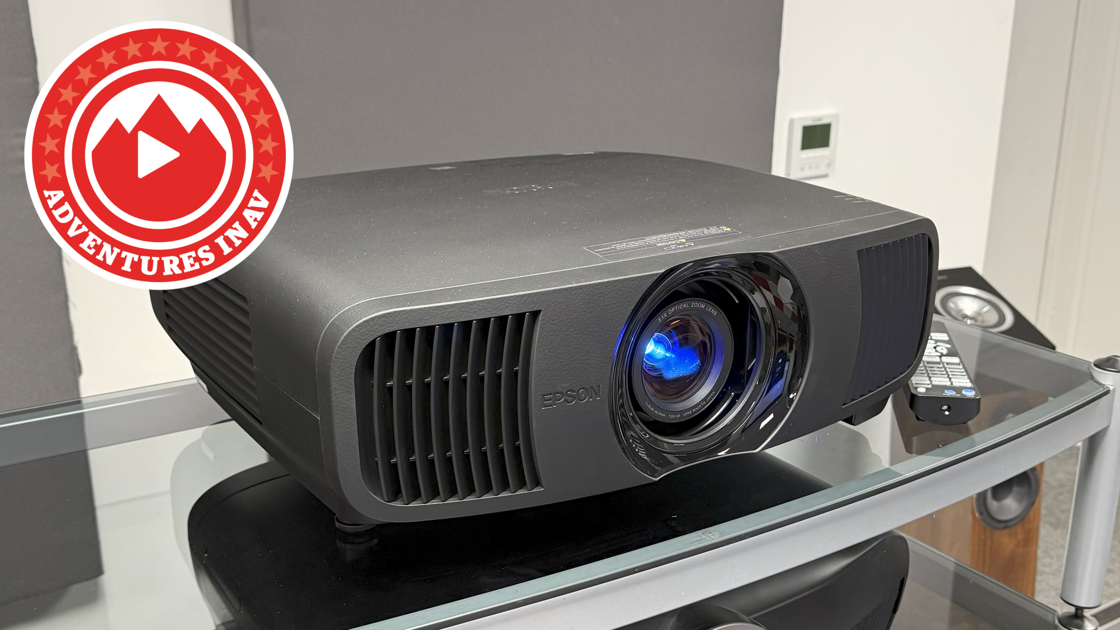 An Epson projector on a glass and metal unit