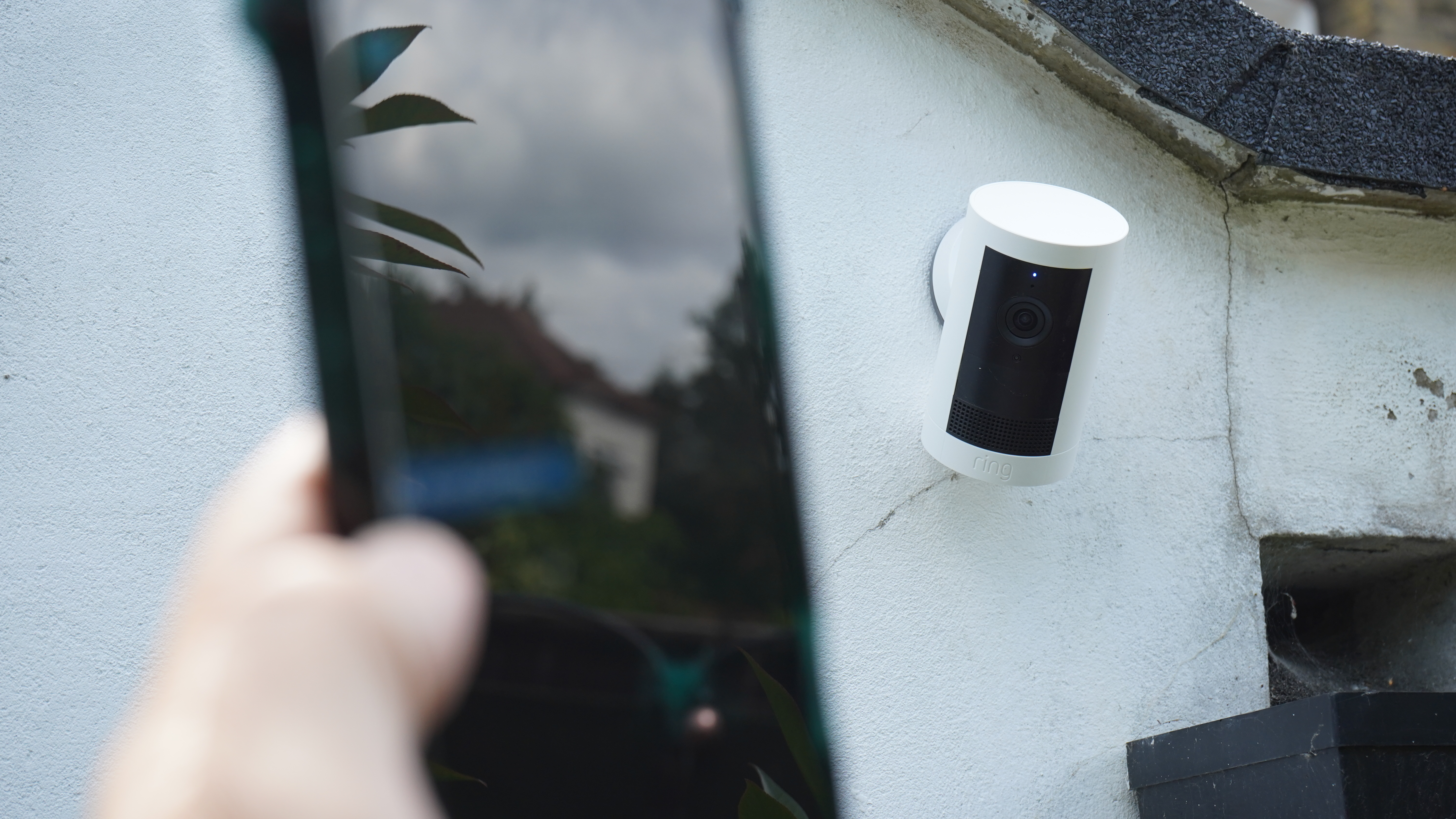 Ring outdoor cam plus with phone in foreground