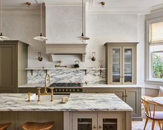 Shaker-style kitchen with green painted cabinets and marble countertops