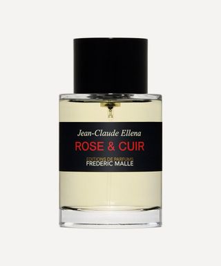 frederic malle rose & cuir perfume in glass bottle against grey background