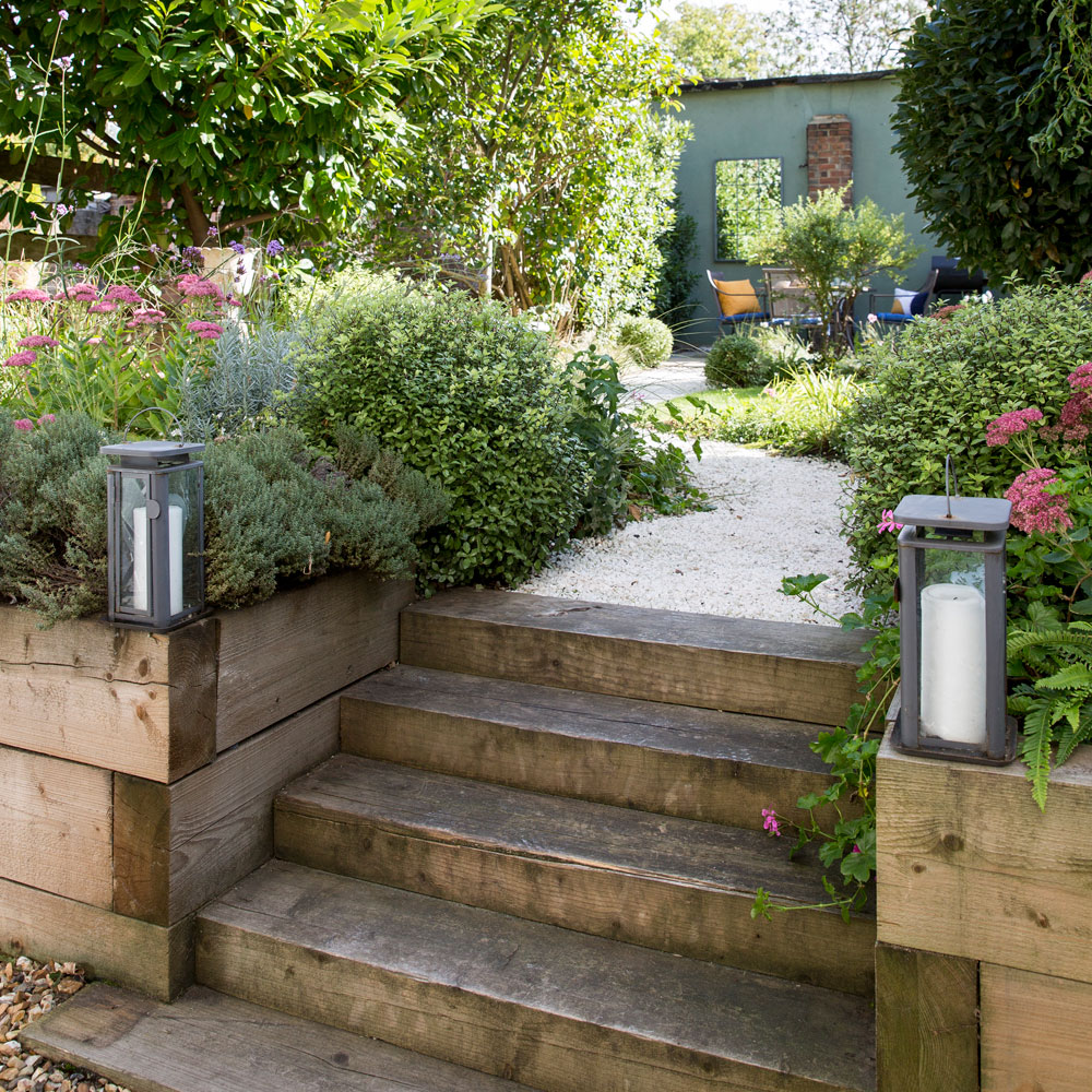 garden area with flower plants and wooden steps