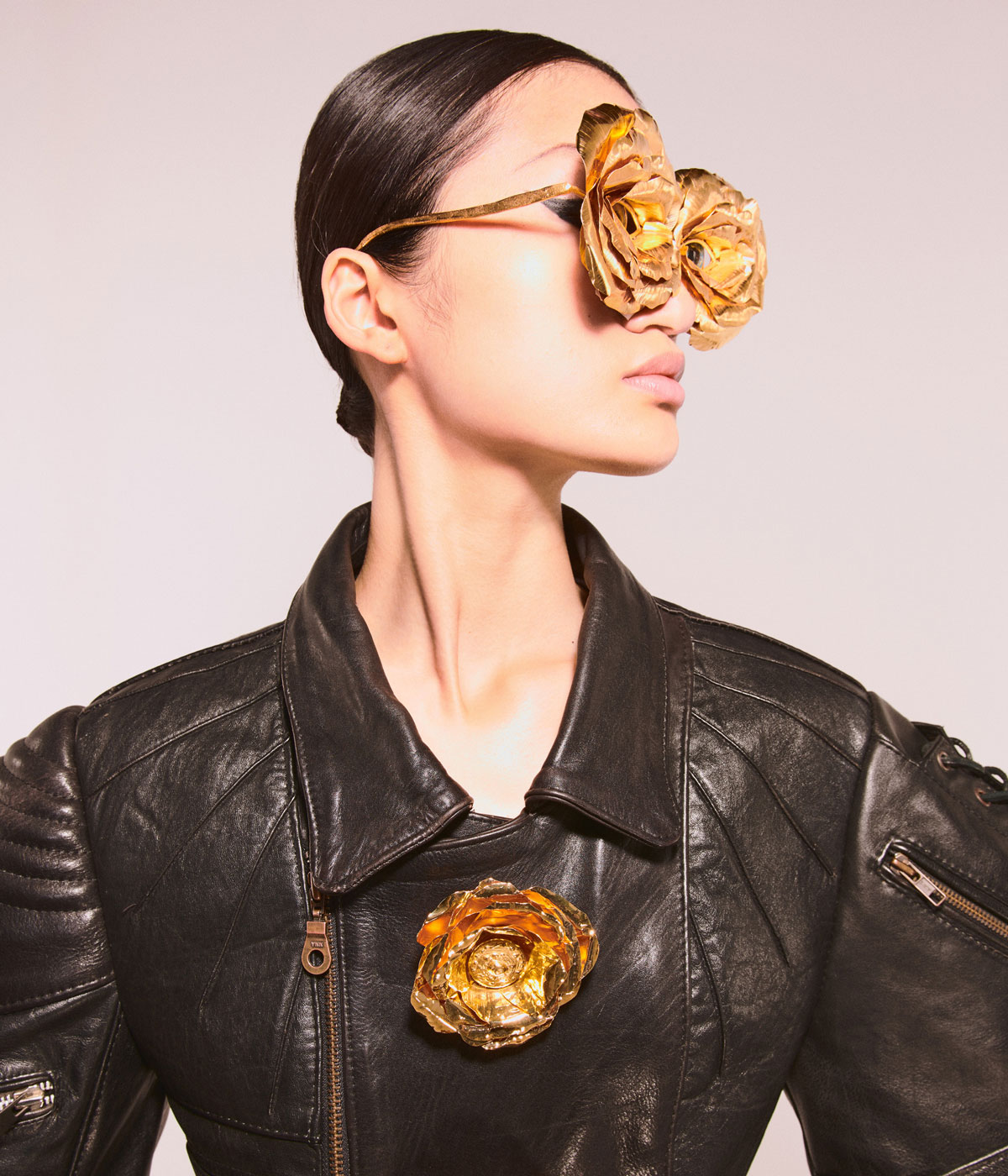 Woman wearing gold glasses with flower on them