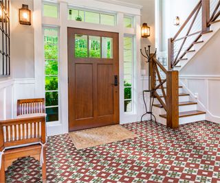 large entryway with patterned floor tiles and door with sidelights