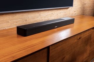 Bose Soundbar on mantle below TV.