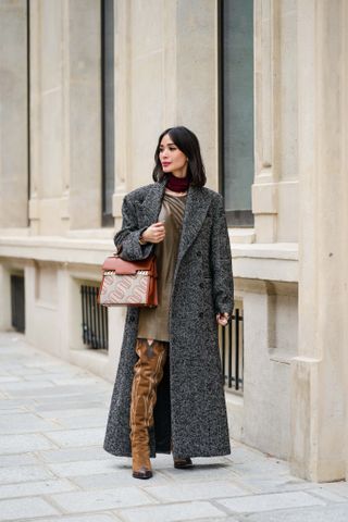 woman wearing gray coat, mini dress, and boots