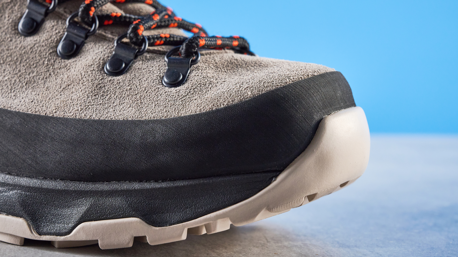 The Columbia Newton Alpine toe box on a stone surface with a blue background