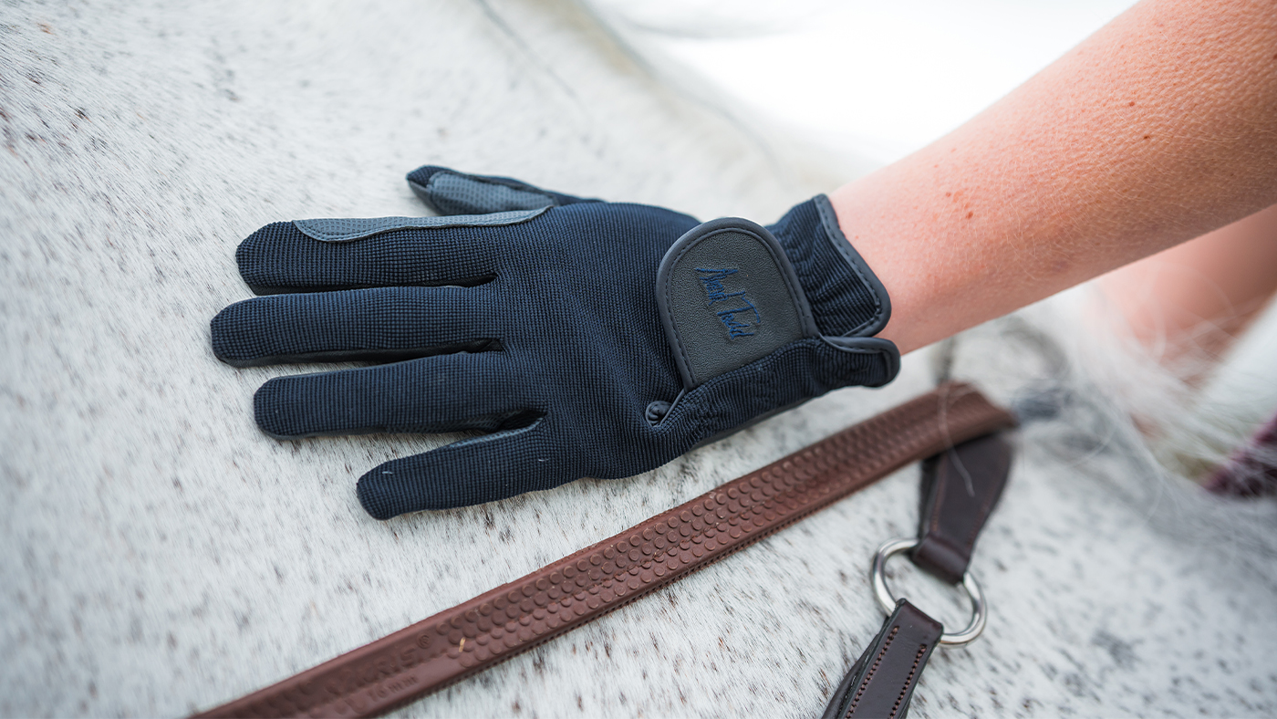 A pair of the best children&amp;rsquo;s riding gloves worn by model on a horse