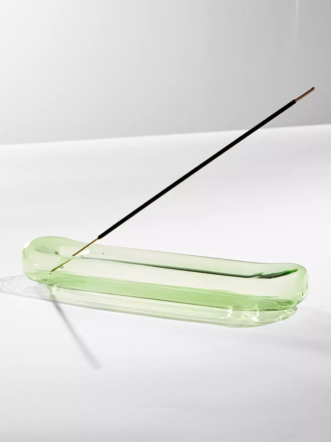 A green glass incense holder from Maegen