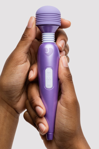 hands holding a purple wand vibrator