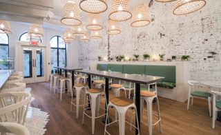 Jacinthe Piotte, and feature whitewashed open brick walls, a tiled marble bar, plant printed banquettes