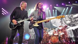 Guitarist Alex Lifeson, bassist Geddy Lee, and drummer Neil Peart of Rush performs at Bridgestone Arena on May 1, 2013 in Nashville, Tennessee.