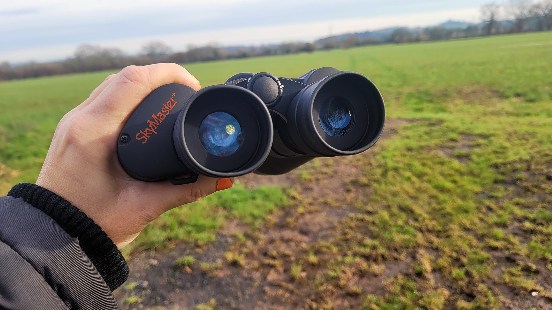 The SkyMaster 12x60 being put to use in a field to search for a missing dog