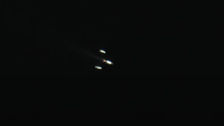 This still from a SpaceX tracking camera video shows the shell-like payload fairing of a Falcon 9 rocket upper stage fall away as planned during SpaceX's launch of the Cosmo-SkyMed Second Generation FM2 satellite for Italy on Jan. 31, 2021 from Cape Canaveral Space Force Station in Florida.