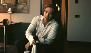 Tenet Robert Pattinson gets ready to pour some coffee
