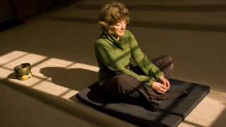 A woman meditating at Gaia House.
