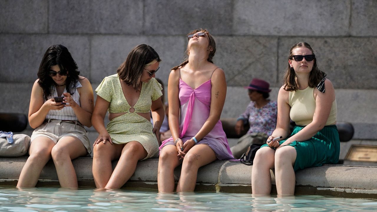 A group of women cool off in Trafalgar Square