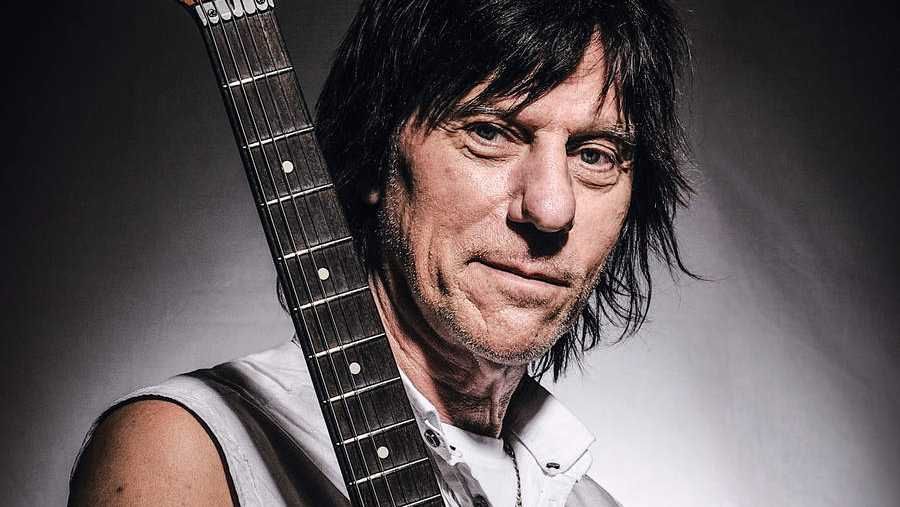 Jeff Beck holding a guitar