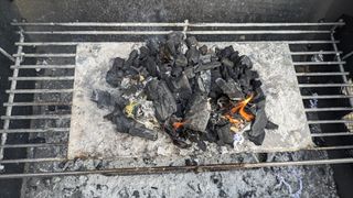 A pile of burning paper and charcoal.