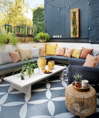 cozy patio with wraparound seating cushions and pattered tiles