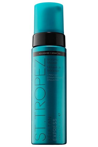 A bottle of St. Tropez Self-Tan Express Mousse against a white background.